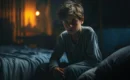 Child sweating at night while sitting awake in bed